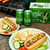 Outdoor setting with a grill, hot dogs, chips, and Partake beer cans on a wooden table.